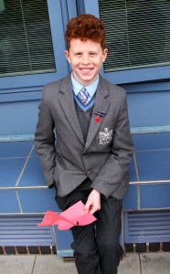 student holding a piece of red paper