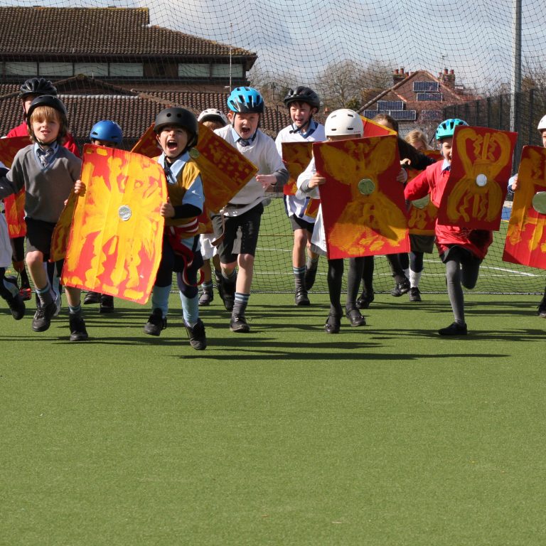 students running with shields