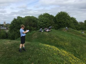 students on the top of grass hills