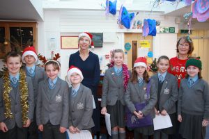 students and teachers in Santa hats