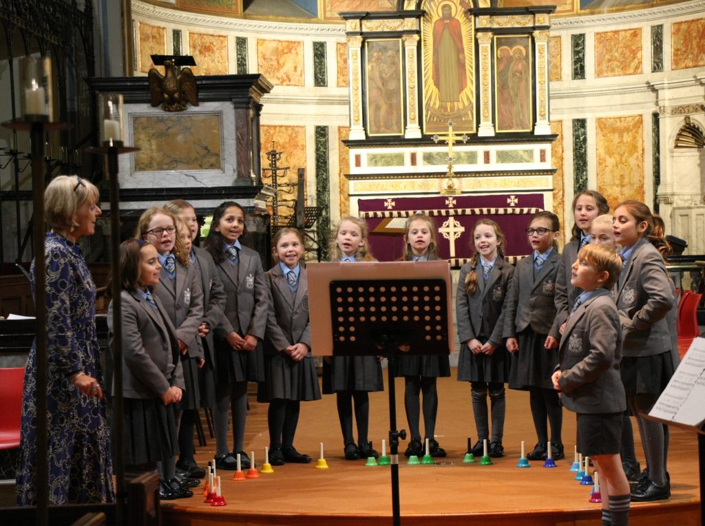children singing at the front of a church