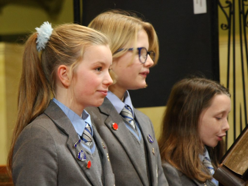 children stood in their school uniform