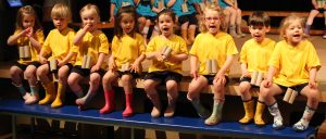 children sitting on stage