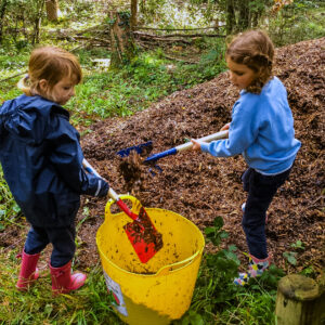students shoveling soil