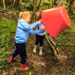 students pouring soil