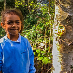 student by a tree