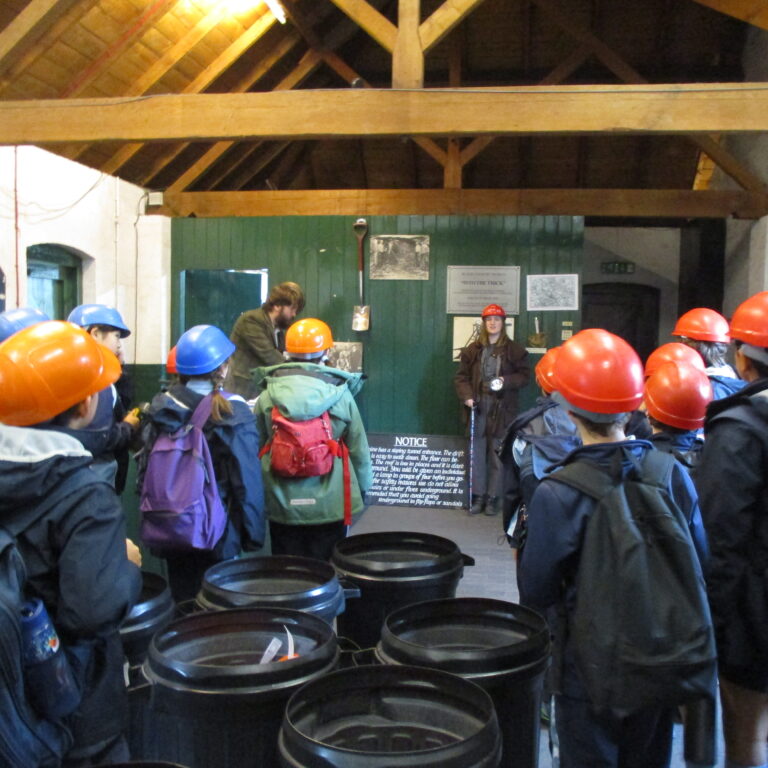 students wearing helmets on a school trip