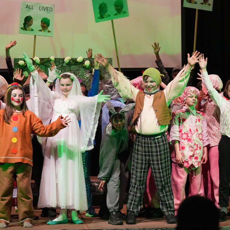 students cheering at the end of their performance